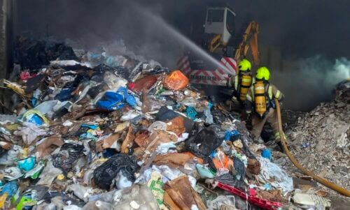 Firefighters putting out a battery fire in a West Sussex waste centre