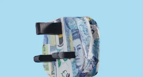 a UK three pin plug wrapped in 5 pound notes - like papier mache