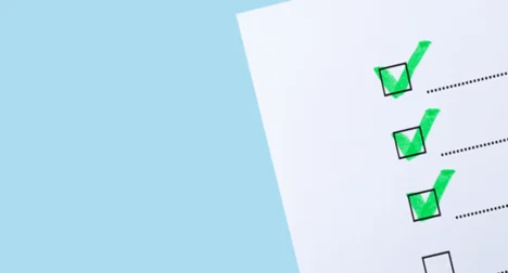 Photo shows checklist with green ticks, cutout on blue background