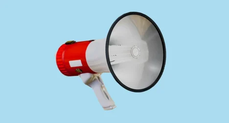 Photo shows a megaphone, cutout on blue background